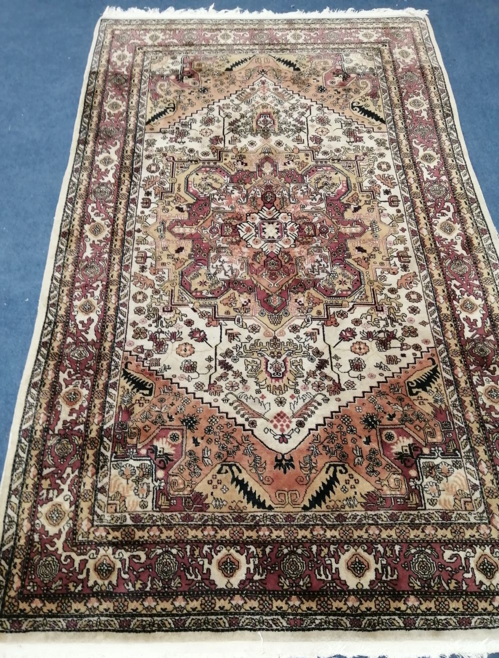 An Eastern ivory ground silk rug, 200 x 115cm